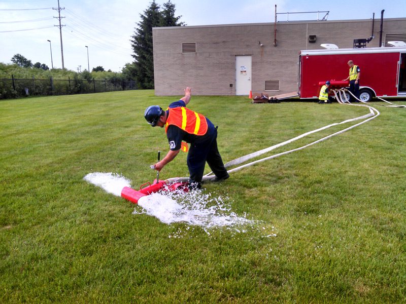 Firefighter testing water hydrant outdoors