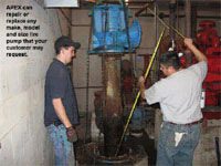 Repairmen working on a vertical pump system